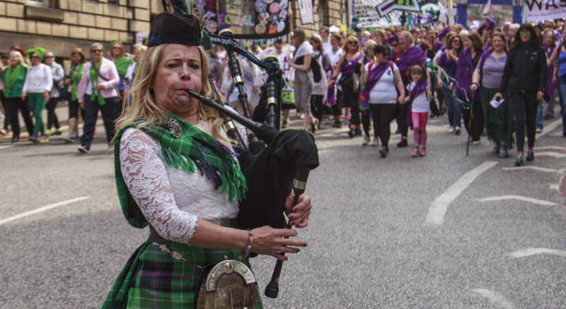 Thousands take part in parade to mark suffrage centenary